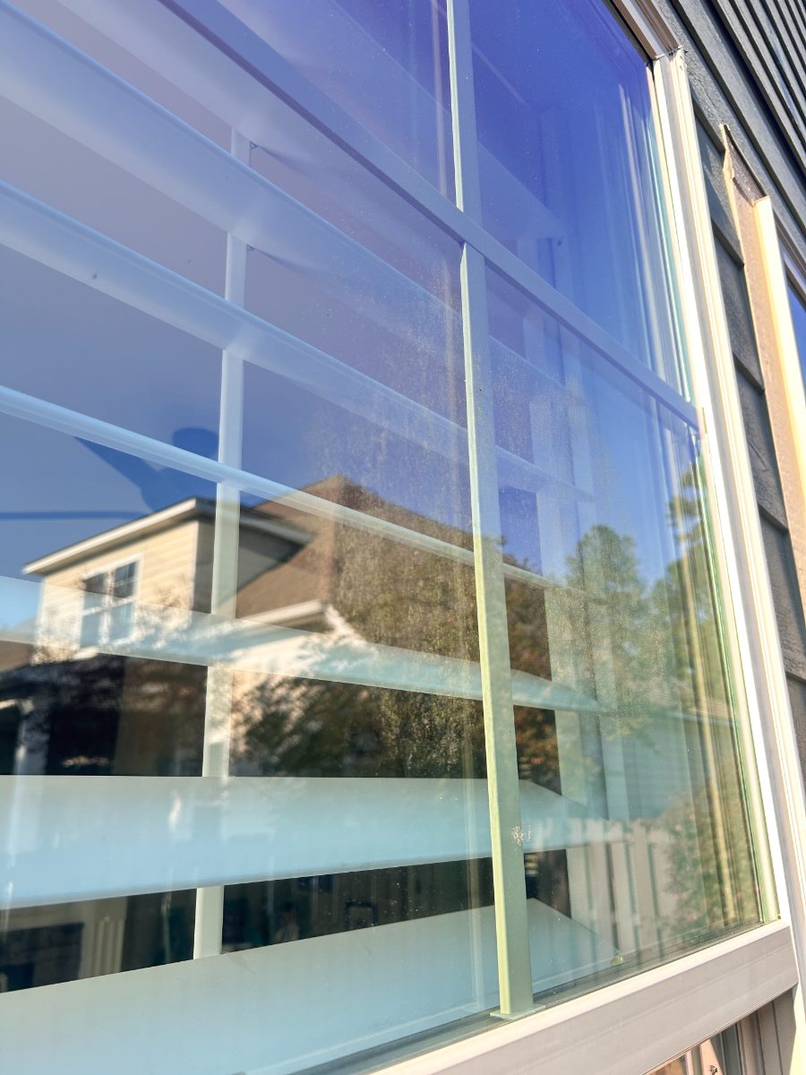 Same window after EXClean cleaning — large picture window, film and water spots removed