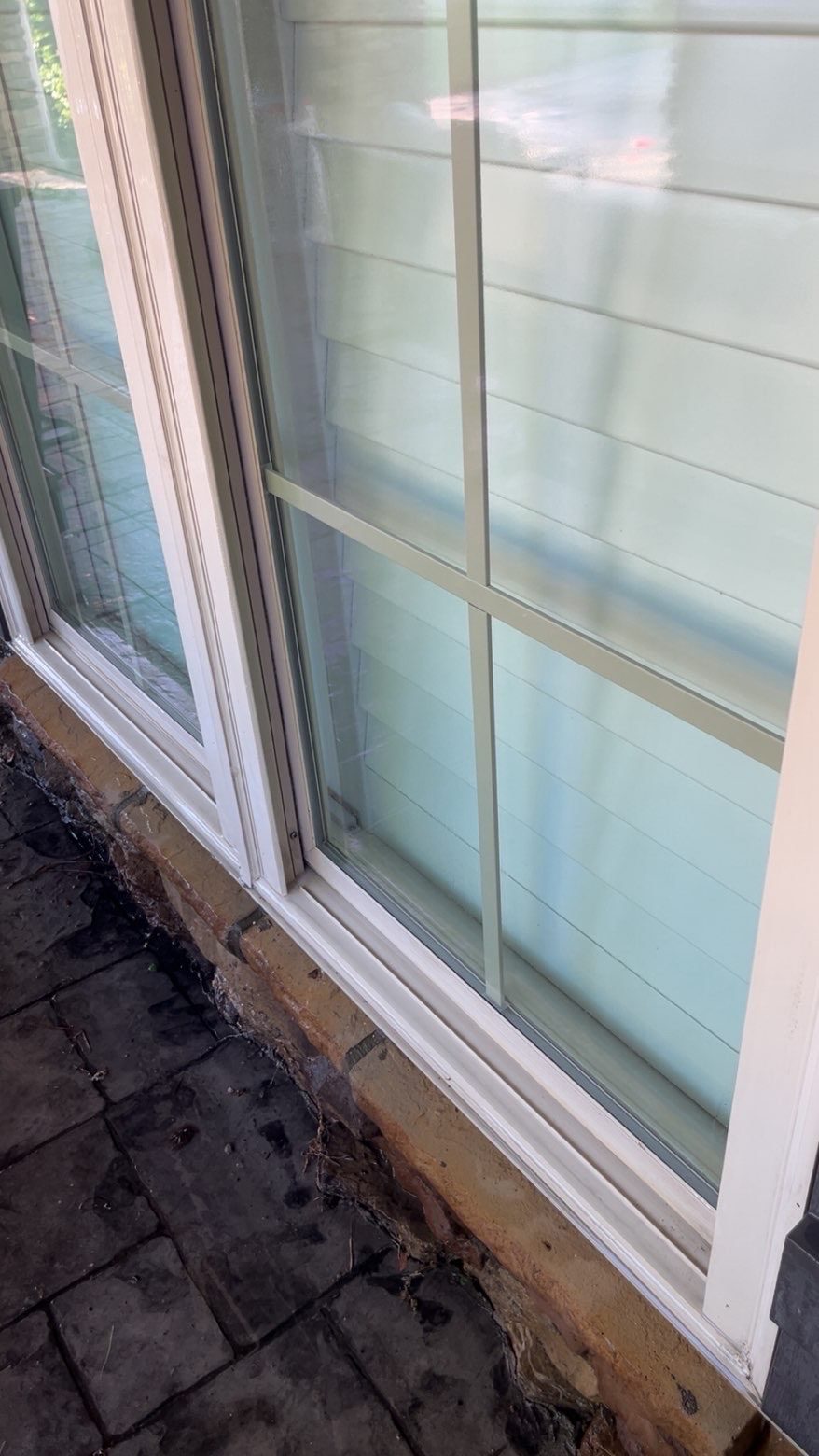 Same window after EXClean cleaning — patio slider brought back to clear