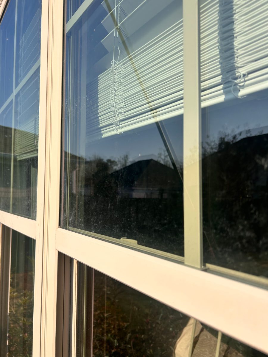 Dirty window before EXClean cleaning — large picture window, film and water spots removed